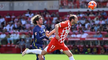 Girona's Dutch defender #17 Daley Blind fights for the ball with Atletico Madrid's Argentine midfielder #05 Rodrigo De Paul during the Spanish league football match between Girona FC and Club Athletic de Madrid at Montilivi Stadium in Girona, on May 25, 2025. (Photo by Josep LAGO / AFP)