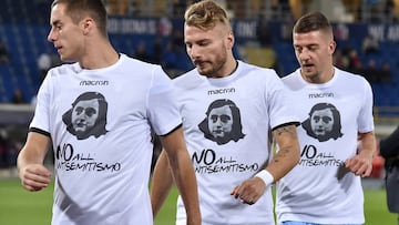 FILE PHOTO: Lazio's players Ciro Immobile (C), Adam Marusic (L) and Sergej Milinkovic-Savic wear a shirt with a picture of Anne Frank before their Serie A soccer match against Bologna at the Dall'Ara stadium in Bologna, Italy October 25, 2017. P