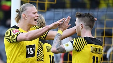 Dortmund's Norwegian forward Erling Braut Haaland (L) celebrates for scoring the 5-0 goal with Dortmund's German forward Marco Reus (R) during the German first division Bundesliga football match Borussia Dortmund v VfL Wolfsburg in Dortmund, wes
