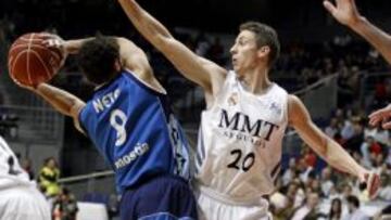 El escolta estadounidense del Real Madrid Jaycee Carroll ante el base brasileño del Gipuzkoa Basket Raulzinho Neto, durante el partido de la trigésimo tercera jornada de la Liga ACB que se juega hoy en el Palacio de Deportes de Madrid.