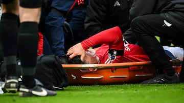 Manchester United's Argentinian defender #06 Lisandro Martinez reacts as he is evacuated on a stretcher following an injury during the English Premier League football match between Manchester United and Crystal Palace at Old Trafford in Manchester, north west England, on February 2, 2025. (Photo by Paul ELLIS / AFP) / RESTRICTED TO EDITORIAL USE. No use with unauthorized audio, video, data, fixture lists, club/league logos or 'live' services. Online in-match use limited to 120 images. An additional 40 images may be used in extra time. No video emulation. Social media in-match use limited to 120 images. An additional 40 images may be used in extra time. No use in betting publications, games or single club/league/player publications. /
