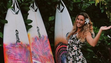 Moanalani Wong, surfista local de Pipeline, en un vestido de flores mostrando sus tablas de surf con el logo de Volcom en la punta. 