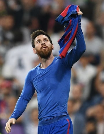 Lionel Messi of Barcelona celebrates as he scores their third goal during the La Liga match between Real Madrid CF and FC Barcelona.