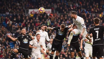 Real Madrid's defender Sergio Ramos (R) heads the ball to score during the Spanish league football match Real Madrid CF vs RC Deportivo at the Santiago Bernabeu stadium in Madrid on December 10, 2016. / AFP PHOTO / PIERRE-PHILIPPE MARCOU