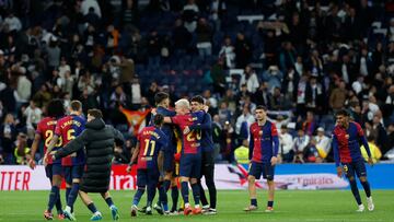 Barcelona players celebrate their victory at the end of the Spanish league football match between Real Madrid CF and FC Barcelona at the Santiago Bernabeu stadium in Madrid on October 26, 2024. (Photo by OSCAR DEL POZO / AFP)