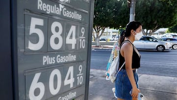 LOS ANGELES, CALIFORNIA - MARCH 25: A pedestrian walks past a gas station advertising gas prices on March 25, 2022 in Los Angeles, California. According to AAA, the average price for one gallon of regular self-service gas in Los Angeles was $6.05 per gall