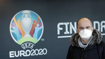 Bucharest (Romania), 17/03/2020.- A passenger wearing a protective mask passes by a UEFA EURO 2020 banner at the arrivals terminal of Henri-Coanda International Airport, in Otopeni, 20 Km north from Bucharest, Romania, 17 March 2020. The UEFA EURO 2020 ha