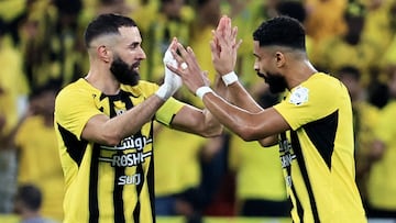 Soccer Football - Saudi Pro League - Al Ittihad v Al Nassr - King Abdullah Sport City, Jeddah, Saudi Arabia - December 6, 2024 Al Ittihad's Karim Benzema celebrates scoring their first goal with Muhannad Al-Shanqiti REUTERS/Stringer