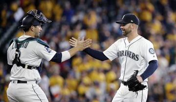 Seattle Mariners closing pitcher Marc Rzepczynski, right, shares congratulations with catcher Mike Zunino after the team beat the Miami Marlins 10-5 in a baseball game Wednesday, April 19, 2017, in Seattle. (AP Photo/Elaine Thompson)