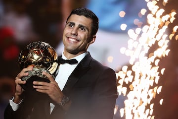 Manchester City's Spanish midfielder Rodri receives the Ballon d'Or award.