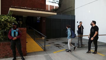 A boy arrives at a school, with social distance marks on the floor, amid a rise in coronavirus disease (COVID-19) cases , in Buenos Aires, Argentina April 19, 2021. REUTERS/Agustin Marcarian