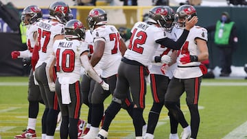 GREEN BAY, WISCONSIN - JANUARY 24: Tom Brady #12 celebrates with Cameron Brate #84 of the Tampa Bay Buccaneers after Brate scored a touchdown in the third quarter against the Green Bay Packers during the NFC Championship game at Lambeau Field on January 2