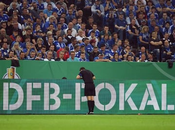 Referee Robert Hartmann looks at the VAR video during the German Cup DFB Pokal semi-final football match Schalke 04 vs Eintracht Frankfurt.