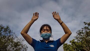 PARANAQUE, PHILIPPINES - FEBRUARY 26: A Filipino Catholic wearing a protective mask prays during Ash Wednesday services at a church on February 26, 2020 in Paranaque city, Metro Manila, Philippines. The Philippines Catholic Church has recommended sprinkli