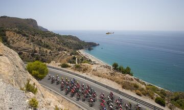 El pelotón pasa por una carretera frente al mediterráneo.