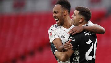 Arsenal's Pierre-Emerick Aubameyang, left, celebrates with Arsenal goalkeeper Emiliano Martinez after scores the winning penalty in a penalty shootout at the end of the English FA Community Shield soccer match between Arsenal and Liverpool at Wembley stadium in London, Saturday, Aug. 29, 2020. (Andrew Couldridge/Pool via AP)
