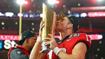 Jan 9, 2023; Inglewood, CA, USA; Georgia Bulldogs quarterback Stetson Bennett (13) kisses the trophy after winning the CFP national championship game against the TCU Horned Frogsat SoFi Stadium. Mandatory Credit: Mark J. Rebilas-USA TODAY Sports