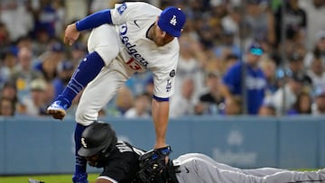 Jul 2, 2025; Los Angeles, California, USA; Los Angeles Dodgers third baseman Max Muncy (13) flips over Chicago White Sox right fielder Michael A. Taylor (21) after tagging him out on an attempted steal in the fifth inning at Dodger Stadium. Mandatory Credit: Jayne Kamin-Oncea-Imagn Images