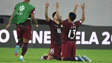 Venezuela's defender Renne Rivas (C) and defender Jesus Paz (R) celebrate their victory at the end of during the Venezuela 2024 CONMEBOL Pre-Olympic Tournament Group A football match between Venezuela and Brazil at the Brigido Iriarte stadium in Caracas, on February 1, 2024. (Photo by Federico Parra / AFP)