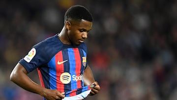 Barcelona's Spanish forward Ansu Fati grabs his jersey during the Spanish league football match between FC Barcelona and Girona FC at the Camp Nou stadium in Barcelona on April 10, 2023. (Photo by Pau BARRENA / AFP)