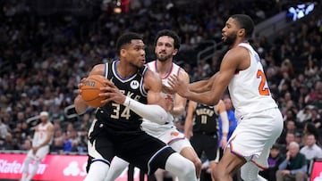 Milwaukee Bucks forward Giannis Antetokounmpo (34) puts up a shot against New York Knicks guard Landry Shamet (44) and New York Knicks forward Mikal Bridges (25) in the first half at Fiserv Forum.