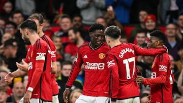 Manchester United's English midfielder #37 Kobbie Mainoo (C) celebrates with teammates after scoring his team first goal during the English Premier League football match between Manchester United and Newcastle United at Old Trafford in Manchester, north west England, on May 15, 2024. (Photo by Oli SCARFF / AFP) / RESTRICTED TO EDITORIAL USE. No use with unauthorized audio, video, data, fixture lists, club/league logos or 'live' services. Online in-match use limited to 120 images. An additional 40 images may be used in extra time. No video emulation. Social media in-match use limited to 120 images. An additional 40 images may be used in extra time. No use in betting publications, games or single club/league/player publications. /