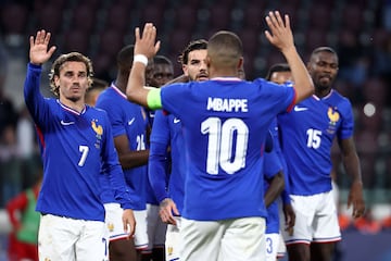 France's midfielder #07 Antoine Griezmann (L) and France's forward #10 Kylian Mbappe gesture during the International friendly