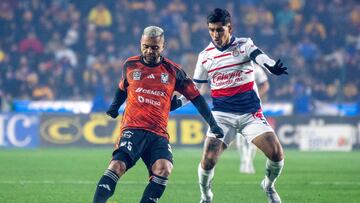 Tigres' Rafael Carioca vies for the ball with Guadalajara's Victor Guzman during the 2024 Mexican Clausura tournament football match between Tigres and Guadalajara at the Universitario Stadium in Monterrey, Mexico, on January 21, 2023. (Photo by Julio Cesar AGUILAR / AFP)