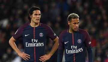 Paris Saint-Germain's Uruguayan forward Edinson Cavani (L) and Paris Saint-Germain's Brazilian forward Neymar react during the French Ligue 1 football match between Paris Saint-Germain (PSG) and Lyon (OL) at the Parc des Princes stadium in Paris.