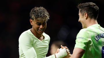 Barcelona's Spanish forward #19 Lamine Yamal celebrates with Barcelona's Polish forward #09 Robert Lewandowski scoring his team's third goal during the Spanish league footbal match between Club Atletico de Madrid and FC Barcelona at Metropolitano Stadium in Madrid, on March 16, 2025. (Photo by OSCAR DEL POZO / AFP)