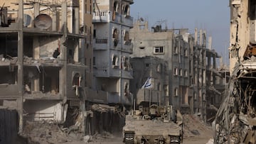 An armoured vehicle drives as damaged buildings are seen in the background, amid the ongoing ground operation of the Israeli army against Palestinian Islamist group Hamas, in the Gaza Strip, September 13, 2024. REUTERS/Amir Cohen EDITOR'S NOTE: REUTERS PHOTOGRAPHS WERE REVIEWED BY THE IDF AS PART OF THE CONDITIONS OF THE EMBED. NO PHOTOS WERE REMOVED. TPX IMAGES OF THE DAY