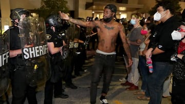 A man confronts police outside the Kenosha Police Department in Kenosha, Wisconsin, U.S., during protests following the police shooting of Black man Jacob Blake August 23, 2020. Picture taken August 23, 2020. Mike De Sisti/Milwaukee Journal Sentinel via U