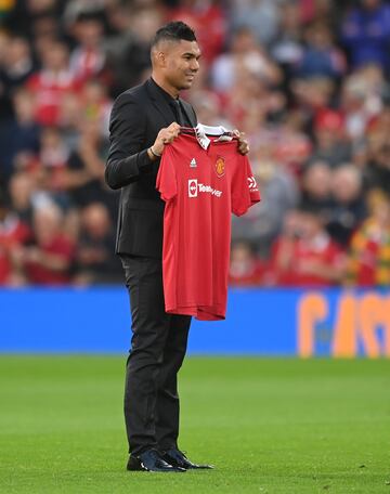 MANCHESTER, ENGLAND - AUGUST 22: New signing, Casemiro of Manchester United poses with a shirt prior to the Premier League match between Manchester United and Liverpool FC at Old Trafford on August 22, 2022 in Manchester, England. (Photo by Michael Regan/Getty Images)