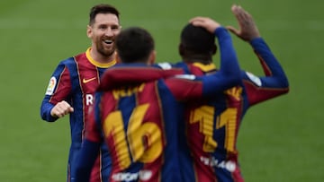 Barcelona's French forward Ousmane Dembele (R) celebrates with Barcelona's Argentinian forward Lionel Messi (L) after scoring a goal during the Spanish league football match between Sevilla FC and FC Barcelona at the Ramon Sanchez Pizjuan stadiu