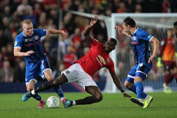 Rochdale's Stephen Dooley Manchester United's Paul Pogba during the EFL Cup match.