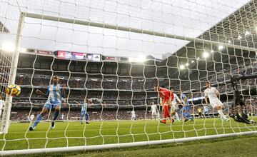 Málaga's Paul Baysse has the ball in Real Madrid's net on the stroke of half time, but sees his header ruled out for a push on Dani Carvajal.