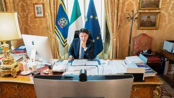 (FILES) In this file photo taken and handout on April 23, 2020 by the Palazzo Chigi Press Office in Rome, Italy's Prime Minister Giuseppe Conte takes part from his office at Palazzo Chigi in Rome in a videoconference of EU leaders on the virus economic impact, during the country's lockdown aimed at curbing the spread of the COVID-19 infection, caused by the novel coronavirus. - Italians, especially entrepreneurs, are feeling pretty low within the coronavirus epidemic, which will weigh heavily on the eurozone's third largest economy. (Photo by Handout / Palazzo Chigi press office / AFP) / RESTRICTED TO EDITORIAL USE - MANDATORY CREDIT "AFP PHOTO / PALAZZO CHIGI PRESS OFFICE" - NO MARKETING - NO ADVERTISING CAMPAIGNS - DISTRIBUTED AS A SERVICE TO CLIENTS