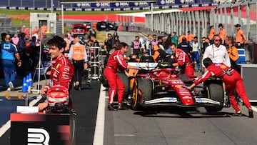Ferrari's Monegasque driver Charles Leclerc (L) stands next to his car after placing third in the Formula One Austrian Grand Prix at the Red Bull Ring race track in Spielberg, Austria, on June 29, 2025. (Photo by Andrej ISAKOVIC / AFP)