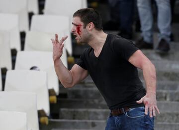 AEK Athens fans jumped onto the pitch and launched flares at the Ajax fans in the Champions League game in Greece on Tuesday night, causing police to intervene.