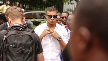 Paris Saint-Germain and France national football team star striker Kylian Mbappe (C) leaves after a meeting with the Prime Minister of Cameroon Joseph Ngute at the Prime Minister's office in Yaounde on July 7, 2023 during a charity visit and a tour of his father's village. (Photo by Daniel BELOUMOU OLOMO / AFP)