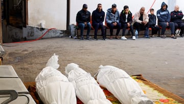 Mourners sit near the bodies of Palestinians killed in an Israeli strike, amid the ongoing conflict between Israel and the Palestinian Islamist group Hamas, at Abu Yousef Al Najjar hospital, in Rafah in the southern Gaza Strip, December 29, 2023. REUTERS/Mohammed Salem