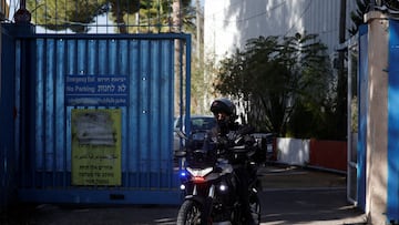 An Israeli police officer rides a bike while leaving the United Nations Relief and Works Agency for Palestine Refugees (UNRWA) headquarters, in Jerusalem December 8, 2025. REUTERS/Ammar Awad