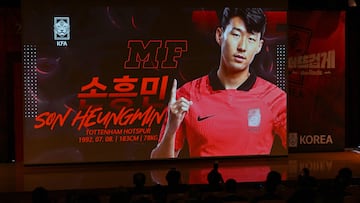 South Korea's footballer Son Heung-min is seen on a screen as journalists look on during a press conference to announce the South Korean squad for the Qatar 2022 FIFA World Cup football tournament, in Seoul on November 12, 2022. (Photo by Jung Yeon-je / AFP)