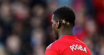 Manchester United's Paul Pogba has two stars shaved into his hair during the English Premier League soccer match between Manchester United and Leicester City at Old Trafford in Manchester