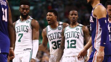BOSTON, MA - MAY 9: Marcus Smart #36 of the Boston Celtics, center, talks with teammates Jaylen Brown #7 and Terry Rozier #12 during Game Five of the Eastern Conference Second Round of the 2018 NBA Playoffs at TD Garden on May 9, 2018 in Boston, Massachus