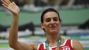 (FILES) Picture taken on August 16, 2016 of Russian athlete Yelena Isinbayeva waving from the stands at the Maria Lenk Aquatics center at the Rio 2016 Olympic Games in Rio de Janeiro . 
 Two-time Olympic pole vault champion Yelena Isinbayeva was elected onto the International Olympic Committee&#039;s athletes commission despite being excluded with the Russian team from taking part in the Rio Games on august 18, 2016. / AFP PHOTO / CHRISTOPHE SIMON