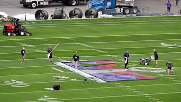 Workers paint a Super Bowl LVIII logo on the field outside of Allegiant Stadium on February 01, 2024 in Las Vegas, Nevada.