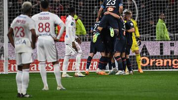 Marseille players celebrate after Marseille's Turkish forward Cengiz Under (not pictured) scores the team's first goal during the French L1 football match between Olympique Lyonnais (OL) and Olympique Marseille (OM) at Groupama Stadium in Decines-Charpieu, central-eastern France on April 23, 2023. (Photo by OLIVIER CHASSIGNOLE / AFP)