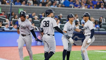 TORONTO, CANADA - JUNE 28: Juan Soto #22 of the New York Yankees celebrates with Anthony Volpe #11 and J.D. Davis #38 as they celebrate Soto's three run home in the sixth inning of their MLB game against the Toronto Blue Jays at Rogers Centre on June 28, 2024 in Toronto, Ontario, Canada. Cole Burston/Getty Images/AFP (Photo by Cole Burston / GETTY IMAGES NORTH AMERICA / Getty Images via AFP)