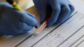 A medical health worker marks a sample testing kit during a community testing exercise, as authorities race to contain the spread of the coronavirus disease (COVID-19) in Abuja, Nigeria April 16, 2020. REUTERS/Afolabi Sotunde